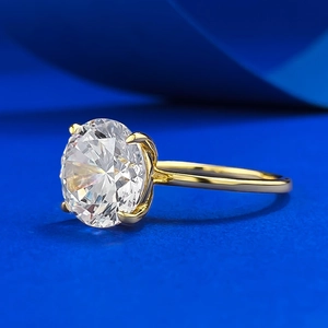 Macro side view of 10mm round sparkling solitaire ring with classic 4-prong gold setting