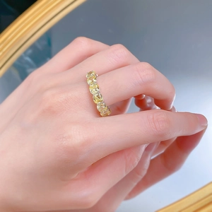Close-up of S925 silver ring featuring a row of oval-cut yellow diamonds on the finger