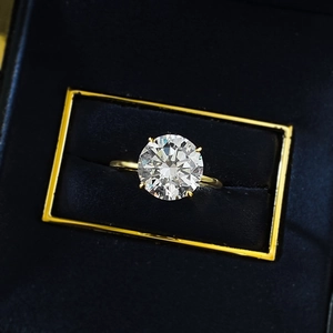 Luxury 10mm round cut silver ring with four-prong setting in a gold velvet gift box