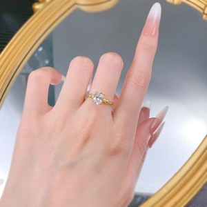 Macro view of gold-plated silver ring with oval gemstone and textured band detail