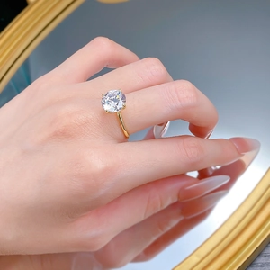Close-up of elegant 10mm round solitaire diamond ring in 14k gold with four-prong setting
