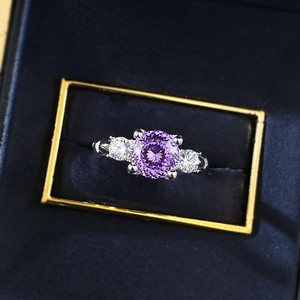 Macro detail of S925 silver ring featuring round purple zircon in blue velvet box