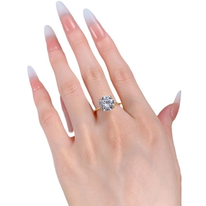 Classic gold four-prong ring with a large round brilliant-cut solitaire diamond on a finger