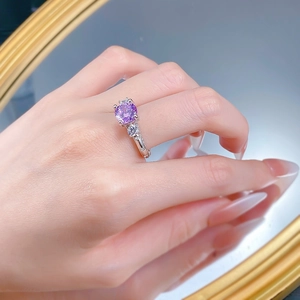 Macro detail of S925 silver ring featuring 8mm purple firework-cut zircon on a hand