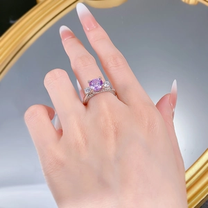 Detailed shot of an S925 silver ring featuring a purple zircon stone and pavé setting