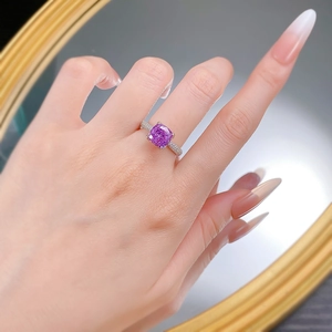 Macro detail of lavender purple cushion-cut gemstone with pavé set diamond band on ring