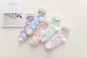 Five pairs of plush coral fleece heart socks in pastel colors for winter warmth