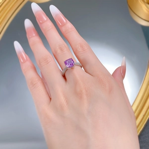 Macro shot of 925 silver ring featuring square lavender stone worn on finger