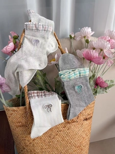 Detailed embroidery of elegant bows on soft cotton mesh socks in various pastel colors