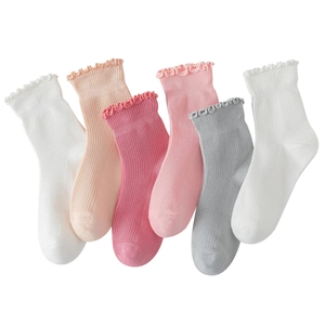 Detail view of six pairs of ribbed cotton socks featuring elegant ruffled lace cuffs in soft colors