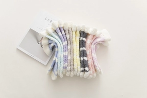 Colorful plush coral fleece socks with polka dots and stripes for cozy winter warmth