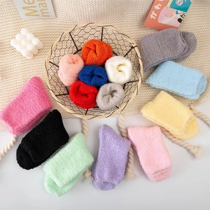 Macro shot of colorful coral fleece socks in multiple pastel shades with cozy texture