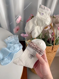 Detail of Korean style mesh socks featuring embroidery bows and plaid cuffs