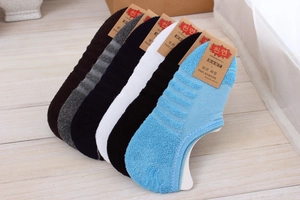 Close-up of 6-pack assorted cotton low cut socks with arch support on wooden floor