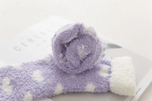 Detail of soft purple fuzzy socks with white dots and thick plush faux fur cuffs