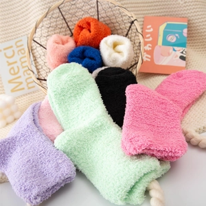 Soft coral fleece thermal socks in various colors stacked neatly for winter home warmth