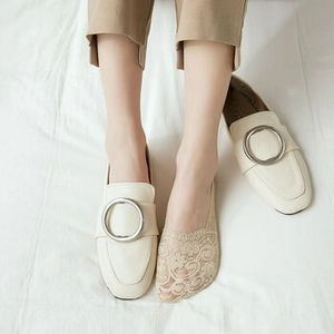 Detail of floral lace no-show socks with silicone grip styled with leather loafers