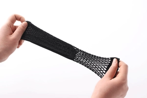 Detail of high-elastic black fishnet fabric showing the diamond mesh texture and stretch