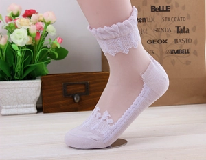 Detail view of pink sheer mesh socks featuring exquisite floral lace embroidery and wavy cuffs