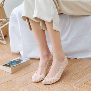 Detailed close-up of beige floral lace invisible boat socks with delicate hollowed texture
