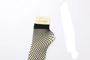 Detail view of black fishnet ankle socks with original cardboard packaging display