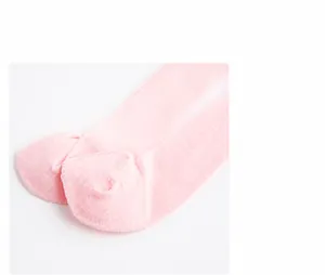 Macro detail of soft pink knit socks showing high-quality heel stitching and texture