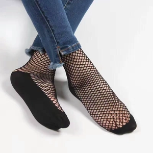 Detail showing black fishnet ankle socks with reinforced solid toe and heel durability