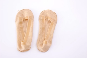 Detail of nude lace invisible boat socks with floral anti-slip silicone grippers on sole