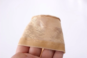 Macro detail of breathable nude mesh lace fabric with stretch and jacquard floral pattern