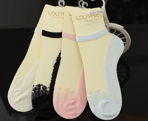 Close-up of four invisible lace socks in white black pink and blue on a mirror