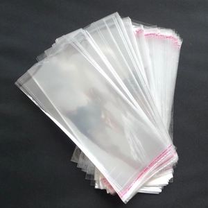 Transparent OPP self-sealing bags for socks with red adhesive strips on black background