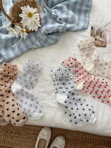 Detail view of heart print sheer mesh socks with ruffled trim in various colors