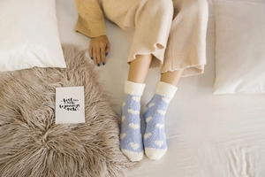 Detail of coral fleece socks with white heart pattern and soft fleece lining cuff