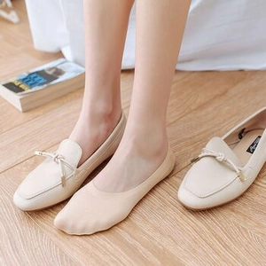 Detailed view of beige square-toe loafers with lace no-show socks for women