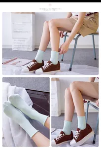 Detailed view of mint green rolled cuff cotton socks shown with stylish brown suede shoes