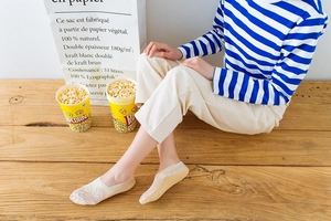 Detailed close-up of beige low-cut lace invisible socks with breathable floral patterns