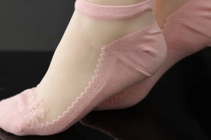 Detail of pink lace no-show socks featuring sheer mesh and breathable cotton sole