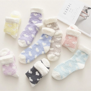 Thick coral fleece socks with heart patterns and folded cuffs in pastel colors