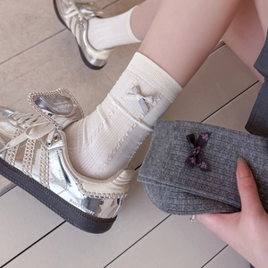 Women's cotton rib-knit crew socks with decorative bows in white and dark grey colors