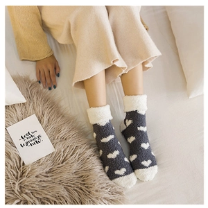 Thick warm coral fleece socks with white heart patterns and fuzzy cuffs for winter