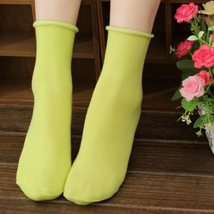 Pale green pure cotton rolled edge socks for women shown on a model display