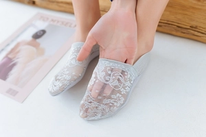 Detail of light gray lace liner socks showing breathable mesh and floral pattern