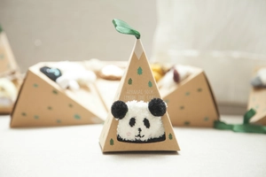 Close-up of fluffy panda coral fleece socks in a premium triangle gift box with silk ribbon