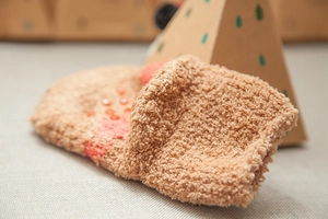 Detailed view of camel fleece kids socks with non-slip silicone dots and soft coral velvet