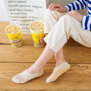 Lace invisible boat socks for women in beige shown in a cozy home setting on wood floor