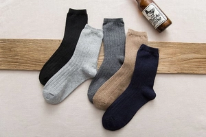 Close-up of five pairs of warm wool blend socks with vertical knit texture for men