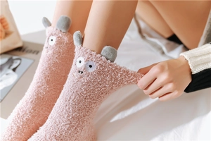Detail of pink coral fleece thermal sock showing elastic stretch and cute 3D ears