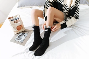 Detail of warm black coral fleece thermal socks featuring cute 3D cartoon animal ears