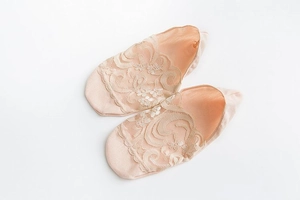 Detailed view of beige lace low cut boat socks with delicate floral embroidery