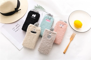 Close-up of five pairs of thick coral fleece socks with cute cartoon monster embroidery